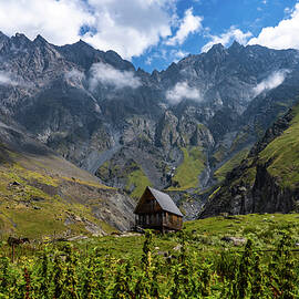 Secluded Cabin Under Towering Mountain Summits